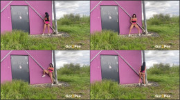 Lexi Dona stands and pees against a building