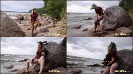 Sexy blonde leans against a huge rock to piss