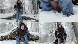 Sexy dark haired girl squats in the snow to piss