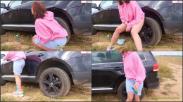 Hipster Girl Pee Next To The Wheel Of The Car