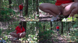 Nikki Dream leans against a tree to piss outside