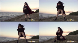 Raven haired babe stands to pee on the beach
